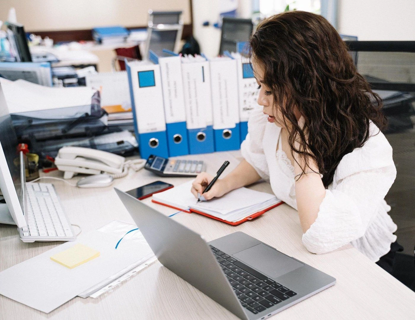 A person reading a report at a desk
