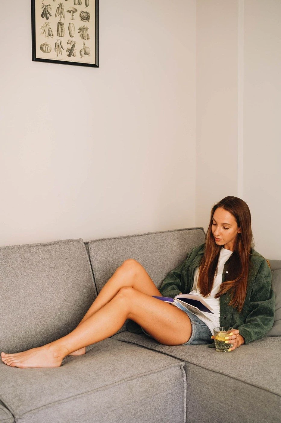 A woman on a sofa reading her phone